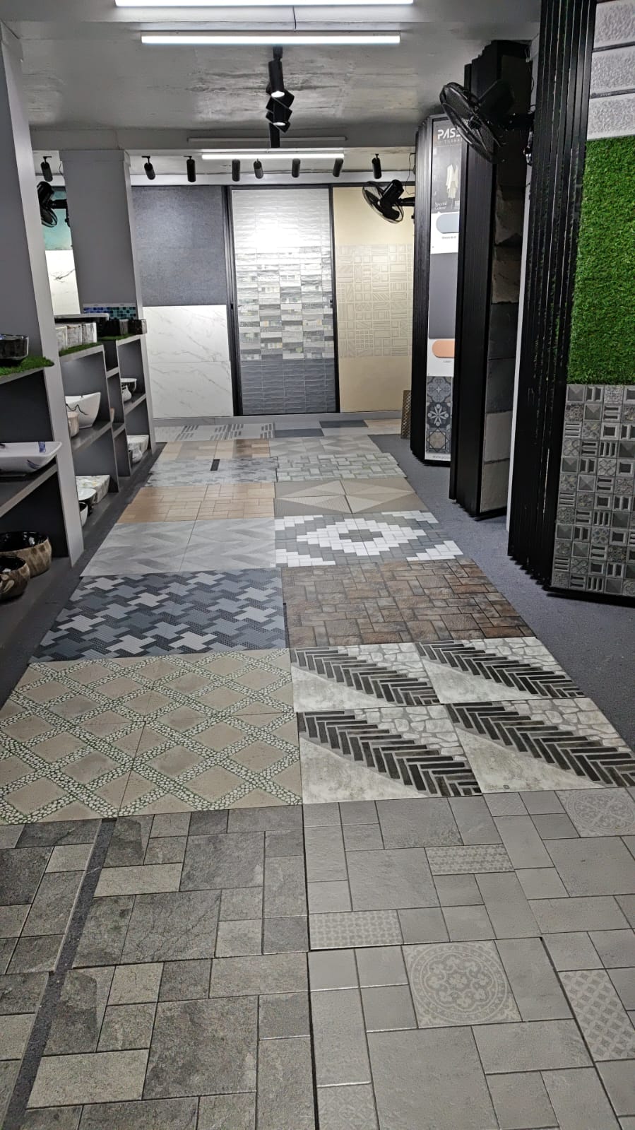 Vitrified floor tiles in stone-look and geometric patterns on showroom floor