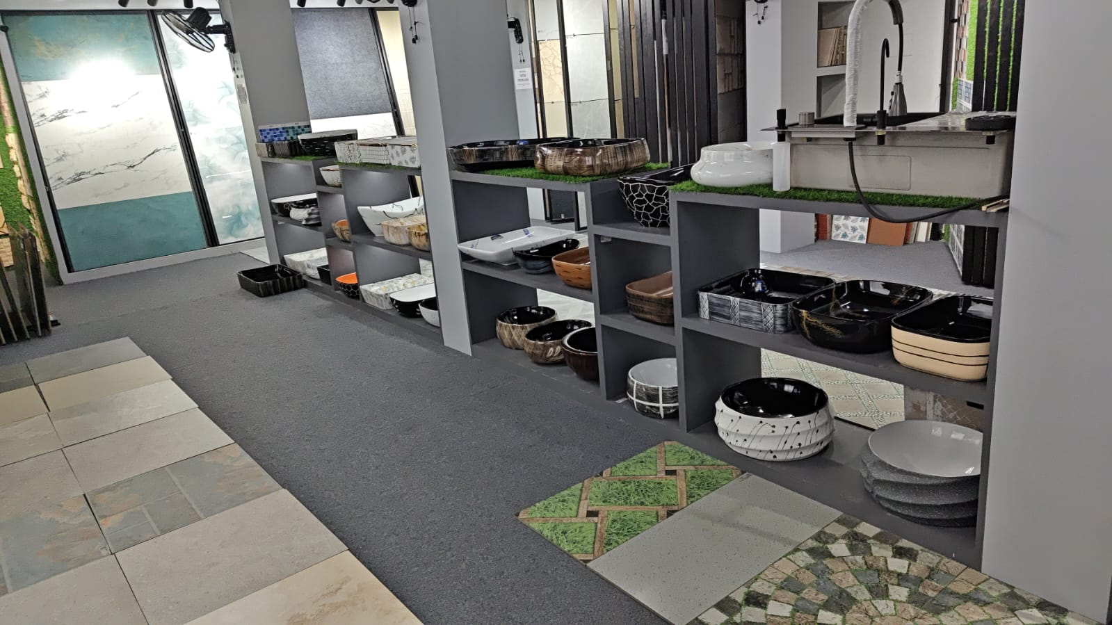 Sanitary ware display shelves at Shree Ceramic showroom with wash basins and fittings